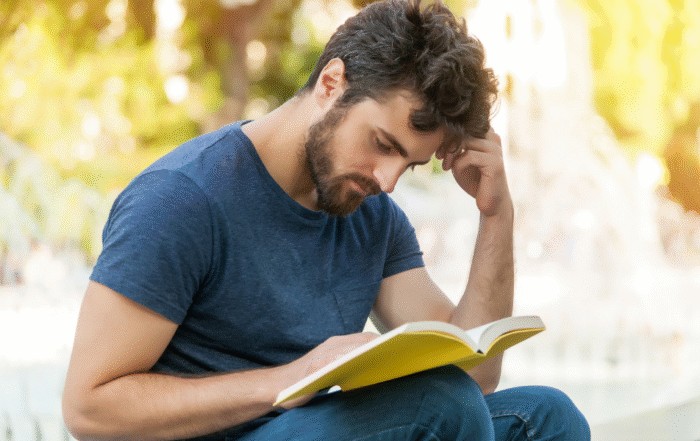 tester 5 A man who's an Enneagram type 6 is reading a book.