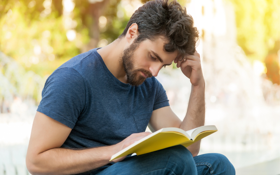 A man who's an Enneagram type 5 is reading a book.
