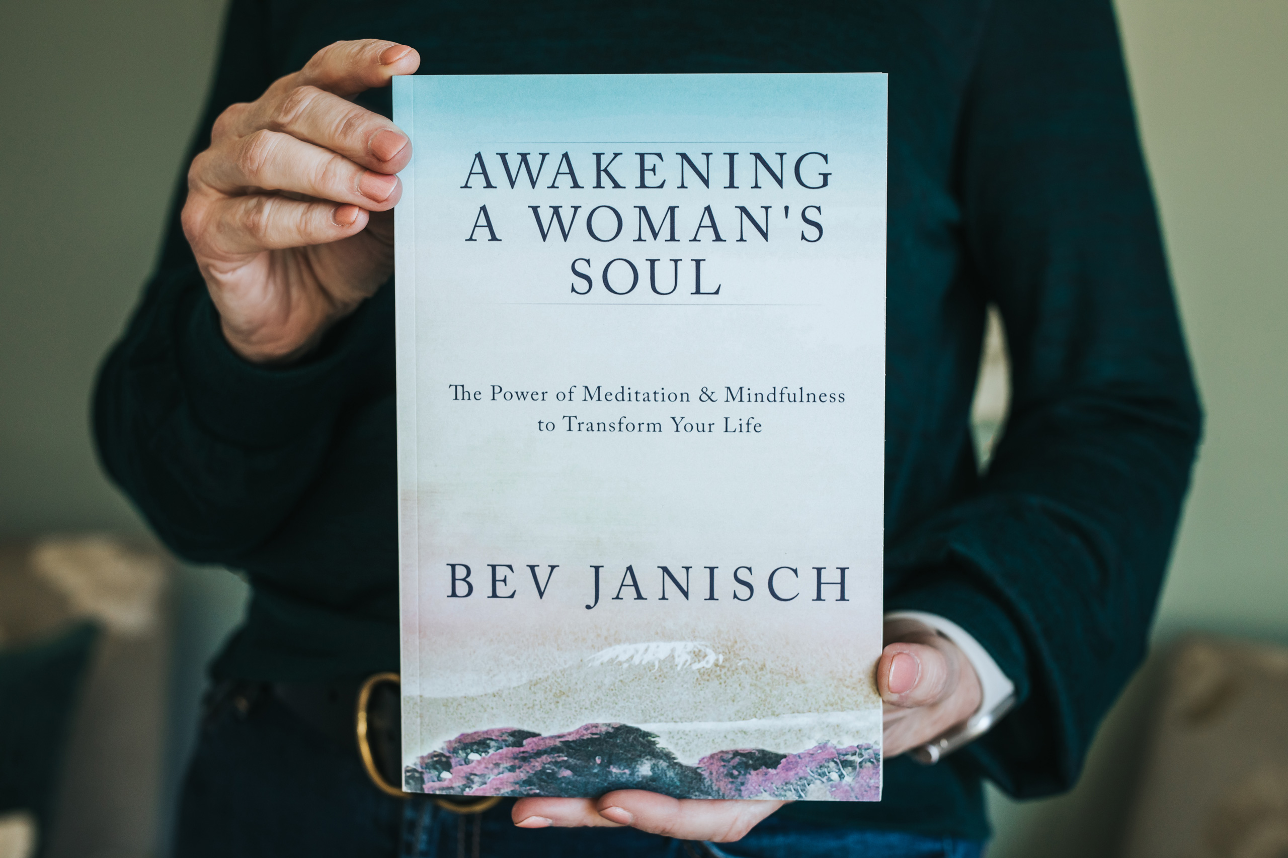 Bev Janisch holding her book, Awakening a Woman's Soul